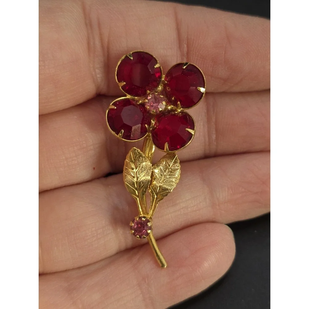 vintage gold-toned floral brooch with red and pink glass rhinestones